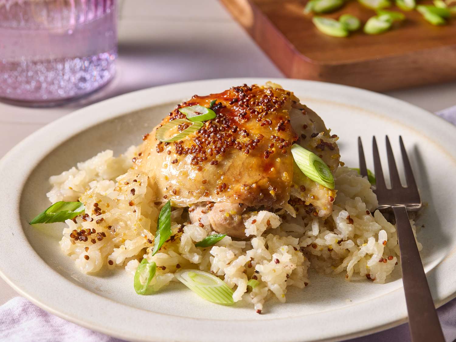Sliced honey mustard chicken breast served over white rice with steamed green beans and extra glaze spooned on top